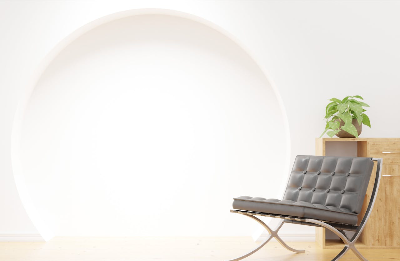 services-01 Stylish lounge corner with modern chair and potted plant in minimalist setting.